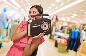 picture of a girl holding a speaker listening to music