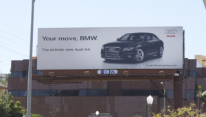 a billboard of Audi advertising it's car by taking a dig at BMW