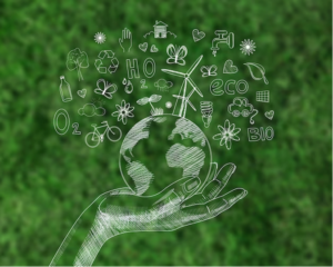Sustainability represented by icons on a globe held by a hand on a green background